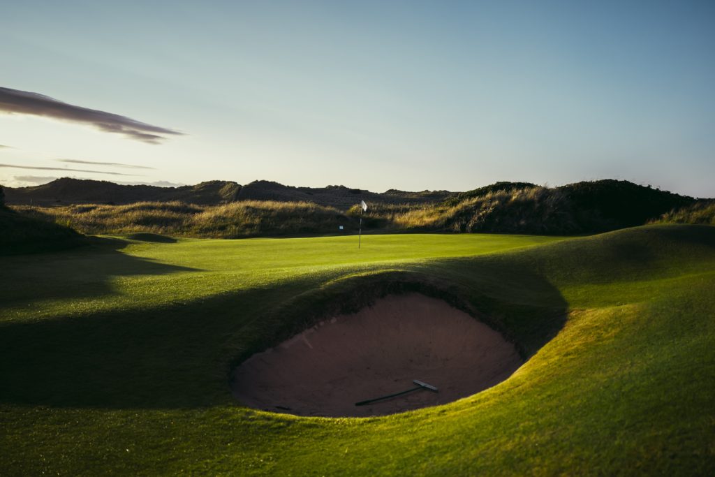 bunker in front of a golf green