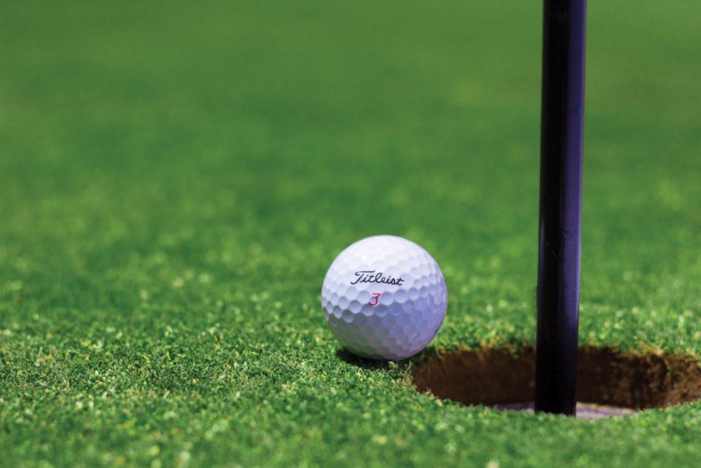 golf ball very close to edge of hole