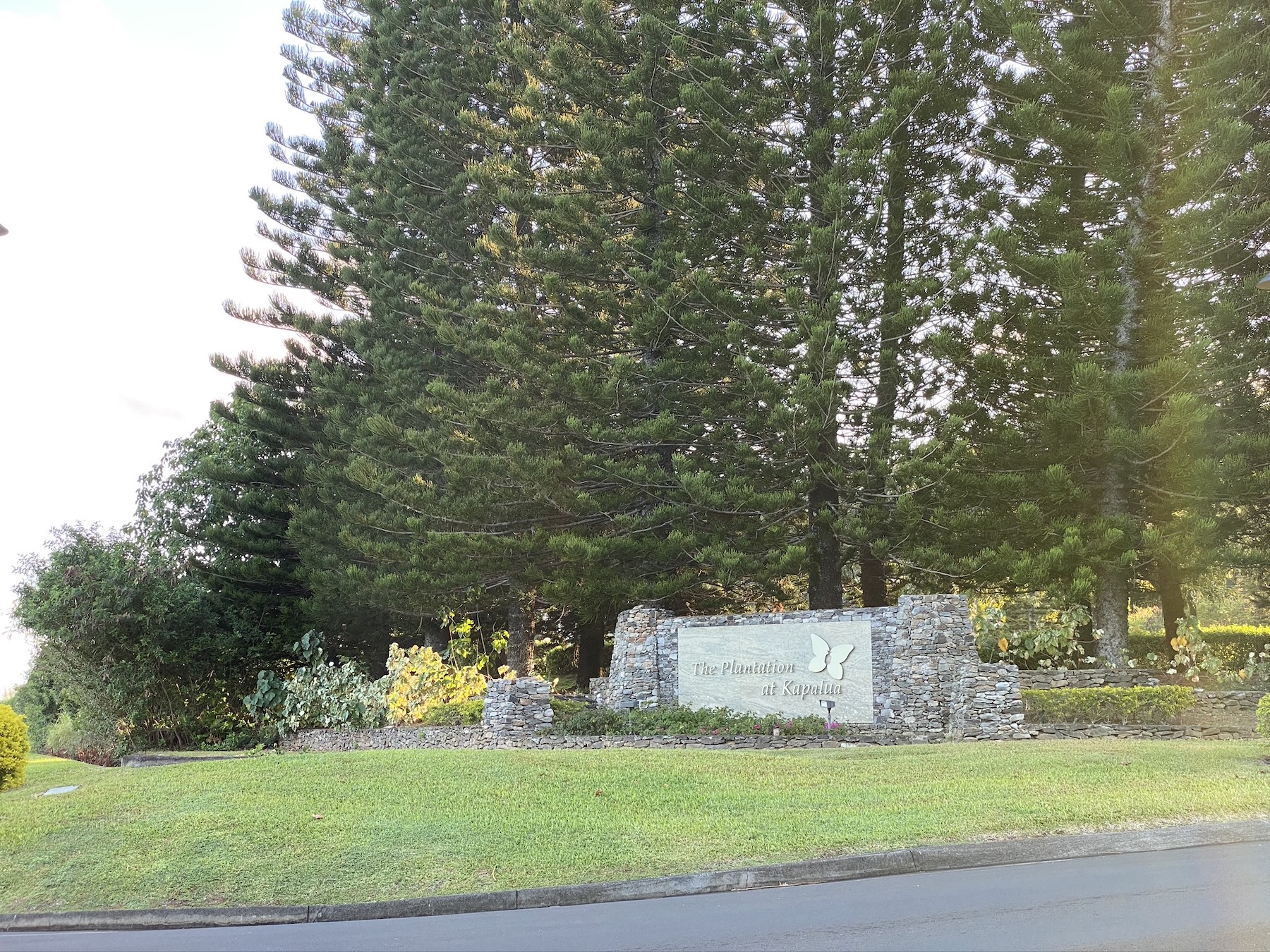 entrance sign to golf course with trees in background